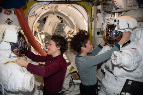 NASA astronauts Christina Koch (left) and Jessica Meir work on their U.S. spacesuits ahead of a spacewalk they conducted to install new lithium-ion batteries (Jan. 15, 2020)