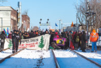 group of protestors looking east with sun good light - Wet'suwet'en Solidarity Event - Toronto Train Stopped at Dufferin Street and Bartlett Avenue in Toronto - Saturday, February 8, 2020