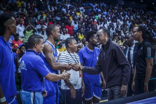 Rwanda's president, Paul Kagame, greets players on Madagascar's GNBC team.