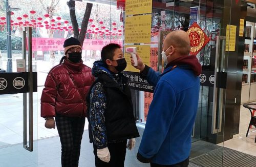 Customers who were measuring body temperature before entering the supermarket in Wuhan during 2019-nCoV coronavirus outbreak