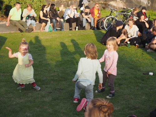 Three small girls dancing at the Herttoniemi Block Party 2019 in Herttoniemi, Helsinki, Finland.