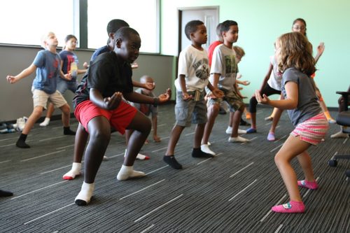 DOBBINS AIR RESERVE BASE, Marietta, Ga., July 15, 2015 - A young camper leads the group during a kids yoga class at "Camp Guard Youth 2015".