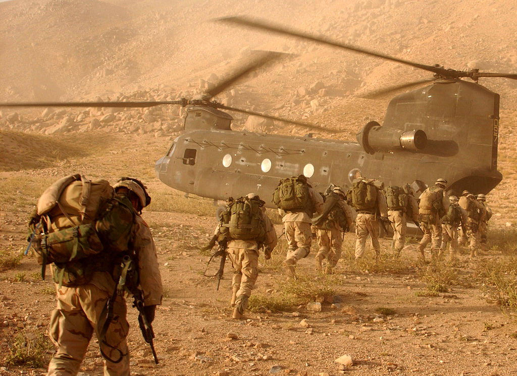 Soldiers return to a helicopter after searching in Daychopan district, Afghanistan, for Taliban fighters and illegal weapons caches.