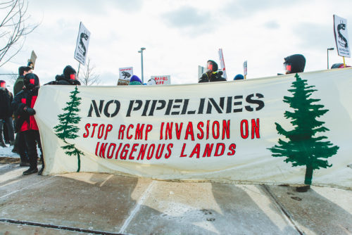 Banner reads "No Pipelines" and "Stop RCMP Invasion on Indigenous Lands" - Wet'suwet'en Solidarity Event - Rail Yard near Pioneer Village Station Blockaded - Vaughan, Toronto, Ontario - February 15, 2020