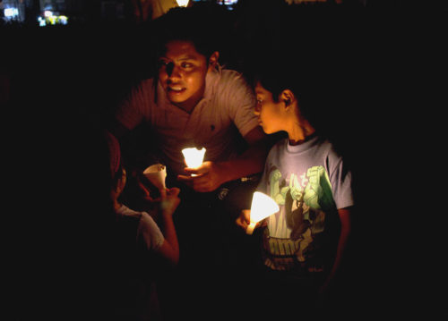 Earth Hour - family lit by small glowing lights