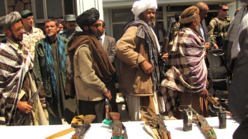Former Taliban fighters line up to handover their Rifles to the Government of the Islamic Republic of Afghanistan during a reintegration ceremony at the provincial governor’s compound.