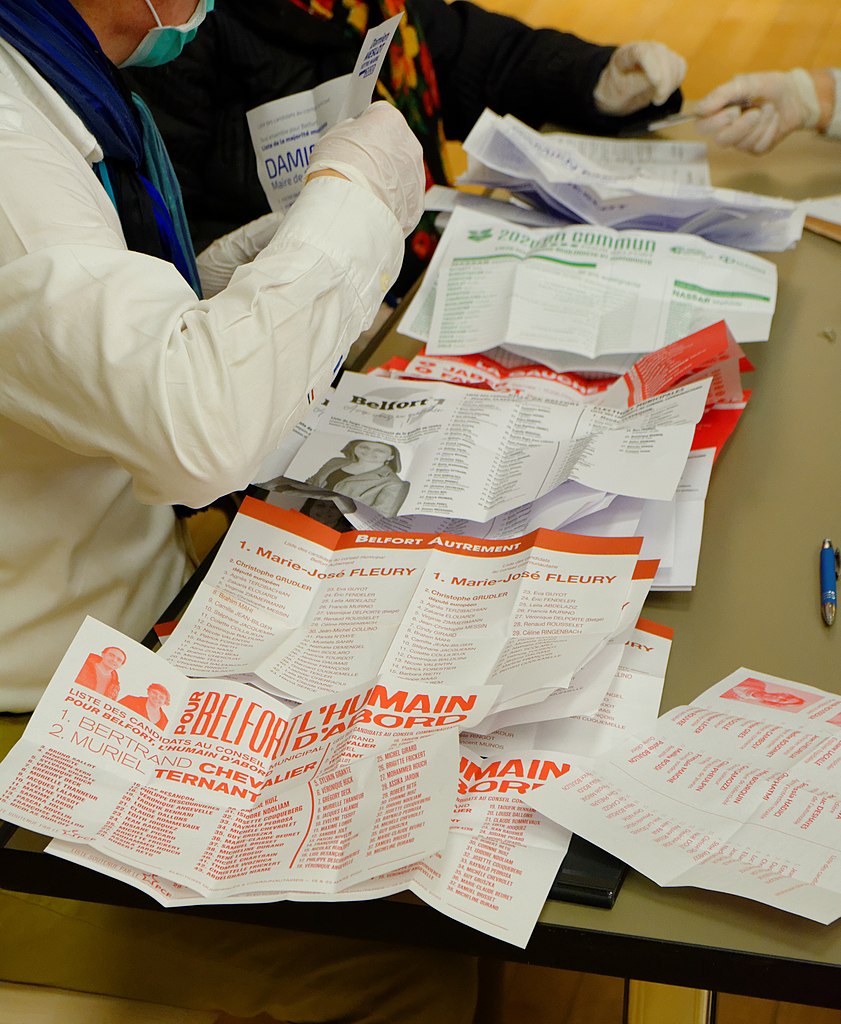 Election workers wearing masks and gloves count ballots after city elections in France on March 15, 2020. (2020-03-15 19-07-02 election-Belfort)