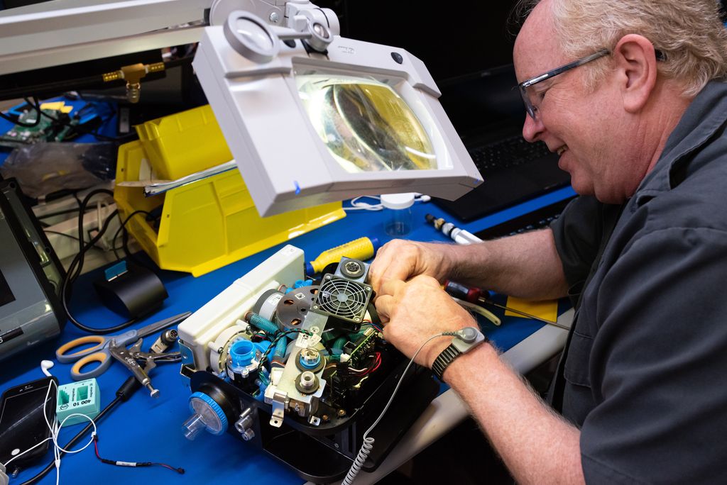 A technician works on a ventilator.