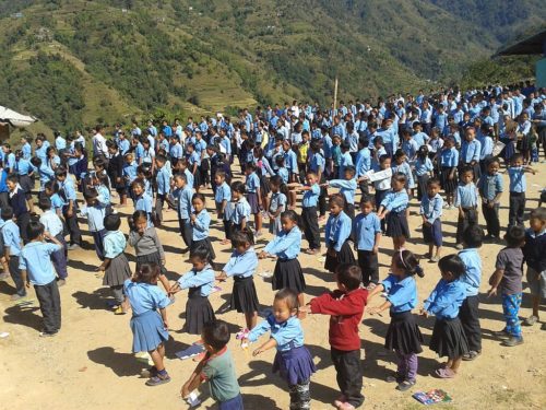 Kids stretching in front of a community school in Nepal