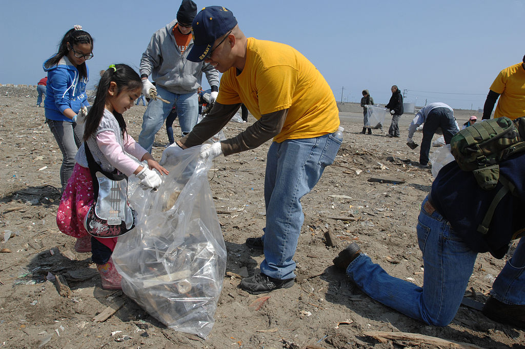 MISAWA, Japan (April 21, 2012) Chief Yeoman Ken Vinoya, center, helps gather trash at the Misawa Fish Port.