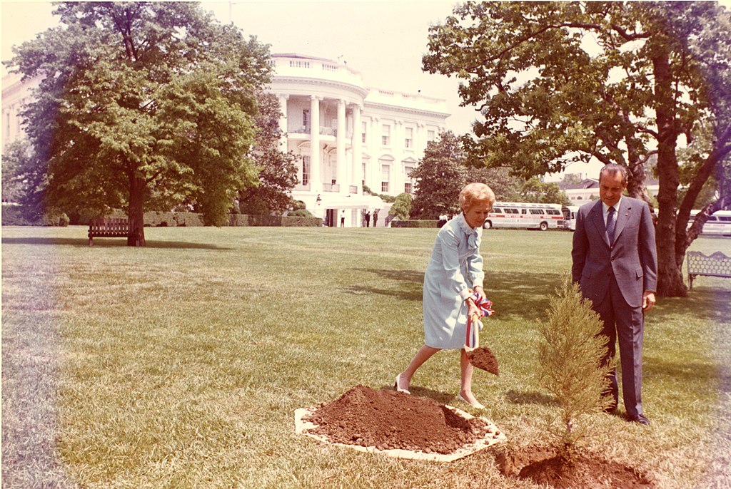 President and Mrs. Richard Nixon plant a tree on the White House South Lawn to recognize the first Earth Day.