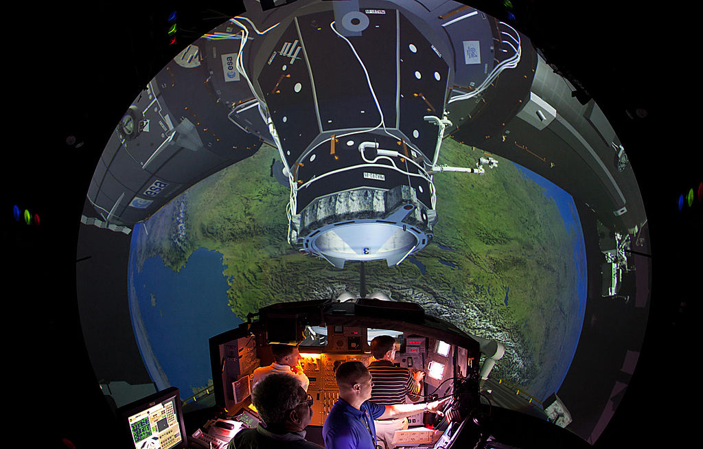 The Crew of STS-135 practices rendezvous and docking with the ISS in the Systems Engineering Simulator at the Johnson Space Center on June 28, 2011 in Houston, Texas.