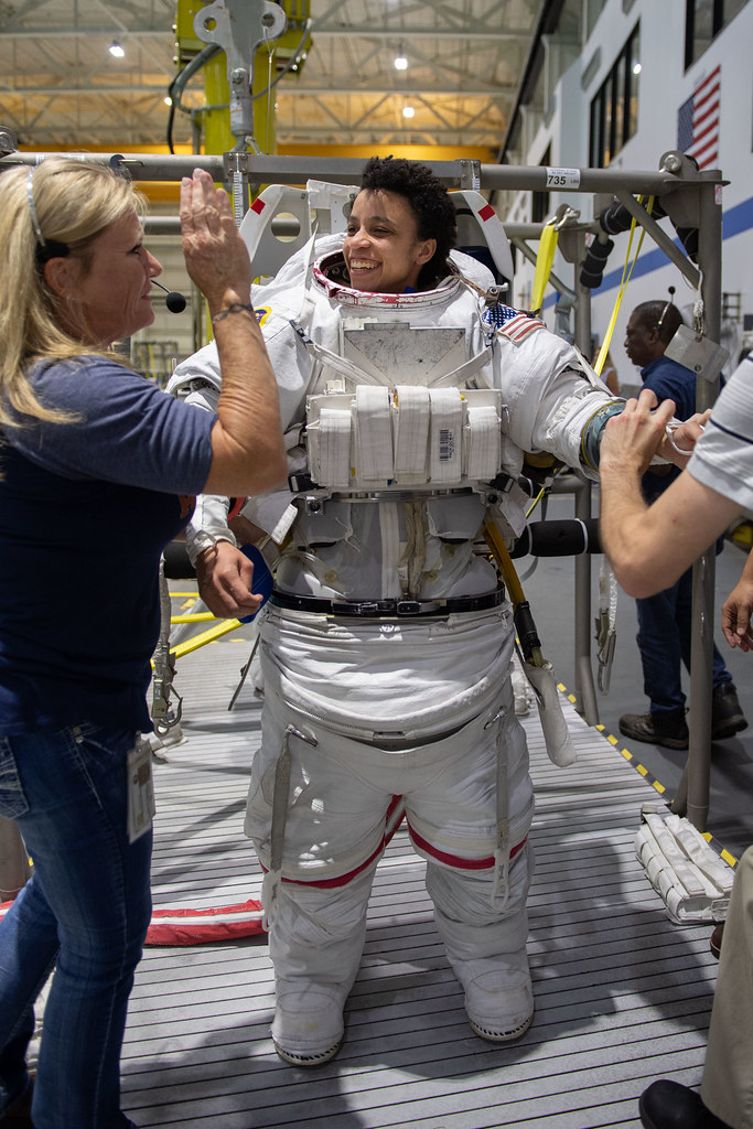 (05-22-19) --- 2017 NASA astronaut candidate Jessica Watkins is helped into a spacesuit prior to underwater spacewalk training at NASA Johnson Space Center’s Neutral Buoyancy Laboratory in Houston. Photo Credit: (NASA/David DeHoyos)