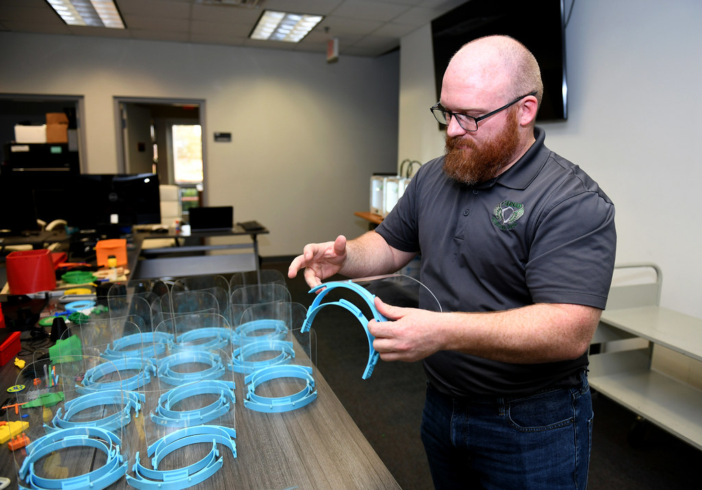 David Hamm inspects a 3D printed face shield as part of the COVID-19 response effort, March 28, 2020.