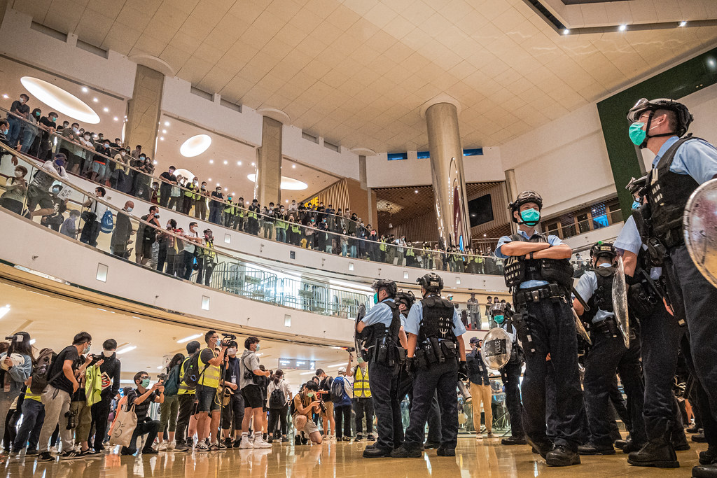 Police face protesters at Hong Kong's City Plaza Mall