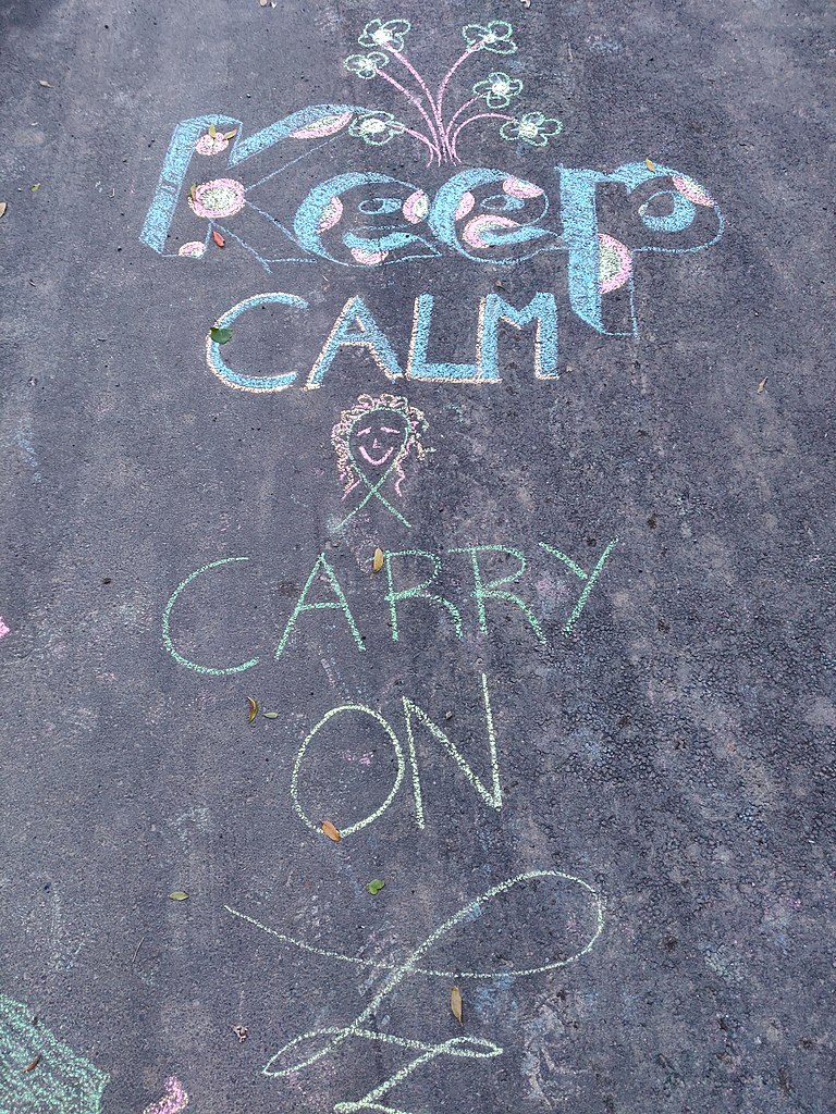 A chalk message saying 'arohanui' on the pavement in Island Bay during COVID-19.