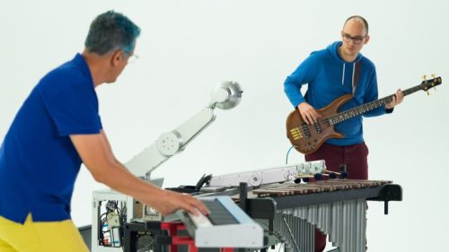 Gil Weinberg and Richard Savery play with Shimon, the musical robot.