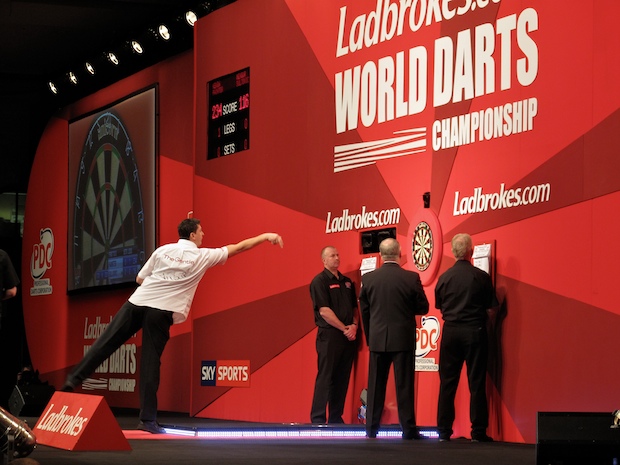 the Gentle Giant, Mensur Suljovic throws a dart at the PDC World Championships.