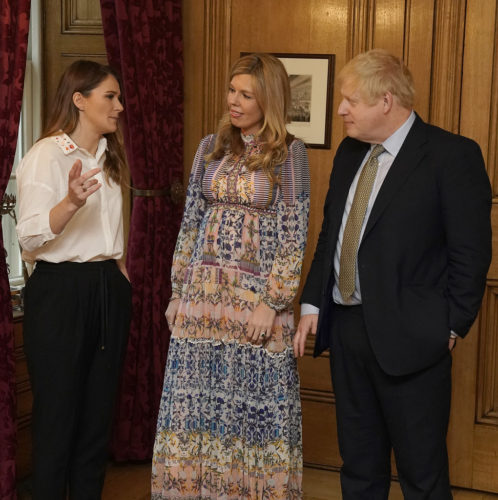 The Prime Minister Boris Johnson and his partner Carrie Symonds talk to Lizzie Carr the winner of the Points of Light Award at International Woman's Day at No 10 Downing Street.