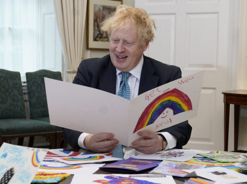 The Prime Minister Boris Johnson in his office in No10 Downing Street with all his Get well soon cards sent in by children while he was ill with the coronavirus.