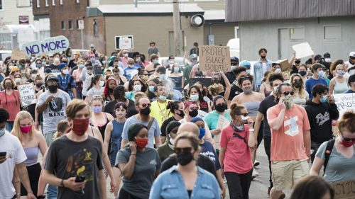 On May 26, 2020, people protested against police violence after the death of George Floyd. Large crowd of protesters in a street.