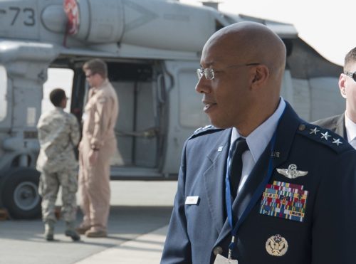 U.S. Air Force Central Command, meets with a crew member from U.S. Navy Helicopter Sea Combat Squadron 26