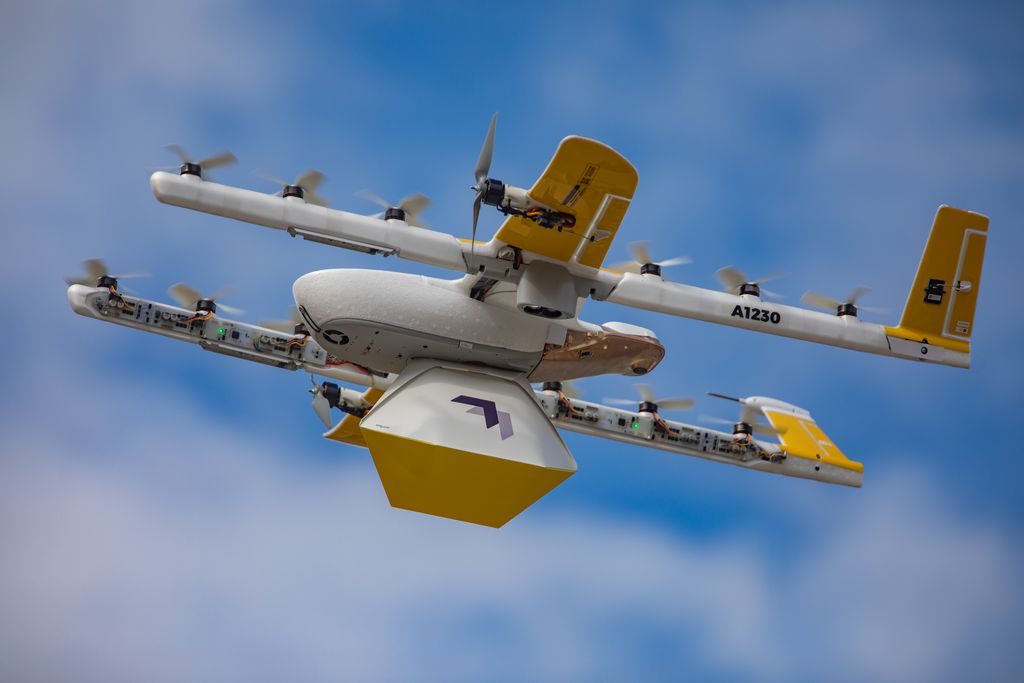 Wing drone with package in the air.