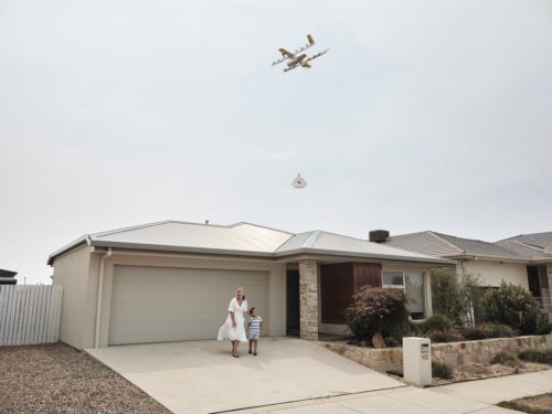 Wing drone with package in the air.