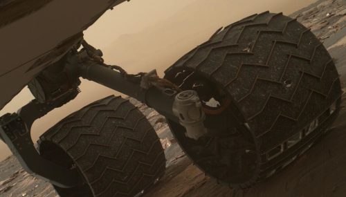 Two of the raised treads, called grousers, on the left middle wheel of NASA's Curiosity Mars rover broke during the first quarter of 2017, including the one seen partially detached at the top of the wheel in this image from the Mars Hand Lens Imager (MAHLI) camera on the rover's arm.