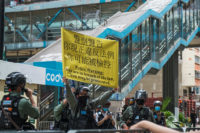 Police held up banners warning the protesters that they could now be arrested based on the signs the held up or the words they shouted or sang.