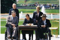 President George H. W. Bush signs the Americans with Disabilities Act of 1990 into law. Pictured (left to right): Evan Kemp, Rev Harold Wilke, Pres. Bush, Sandra Parrino, Justin Dart.