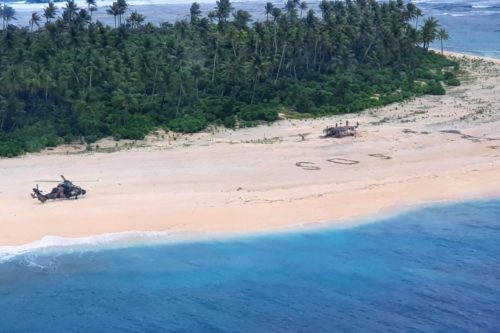 Aerial view of Australian helicopter on beach next SOS.