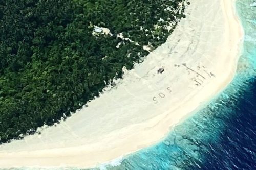 Aerial view of SOS on beach in Micronesia.