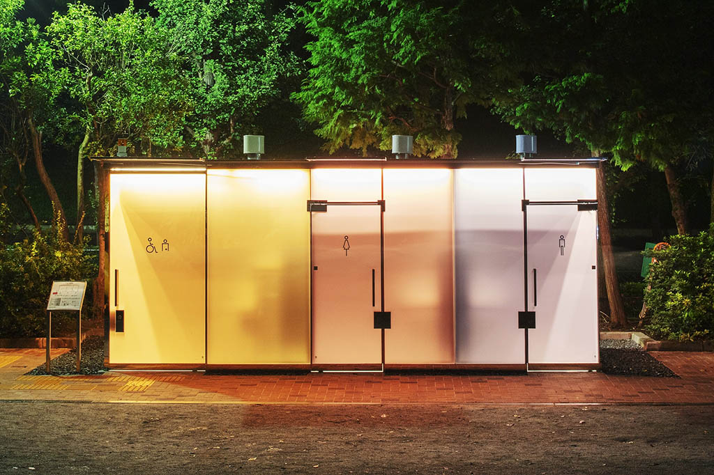 Transparent toilets designed by Shigeru Ban, brightly lit and opaque at night.