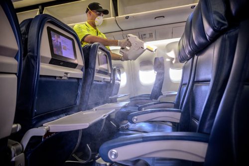 Delta workers disinfect the surfaces of the cabin including tray tables, seat backs and in-flight entertainment screens in a Boeing 757 in Atlanta, Ga., on Friday, March 6, 2020. The sanitizing solution is the same solution used to sanitize hospitals nationwide.