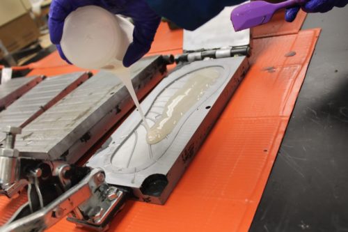 Polyurethane being poured into the mold for a flip-flop.