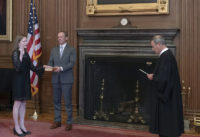 Chief Justice John G. Roberts, Jr., administers the Judicial Oath to Judge Amy Coney Barrett in the East Conference Room, Supreme Court Building. Judge Barrett’s husband, Jesse M. Barrett, holds the Bible.Credit: Fred Schilling, Collection of the Supreme Court of the United States