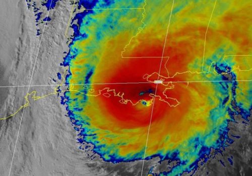 A colored satellite image of Hurricane Zeta as it makes landfall, with a map superimposed.