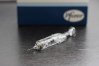 Syringe in front of a Pfizer box.