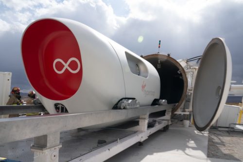 Virgin Hyperloop's XP-2 vehicle in front of the hyperloop tube at the DevLoop test site.