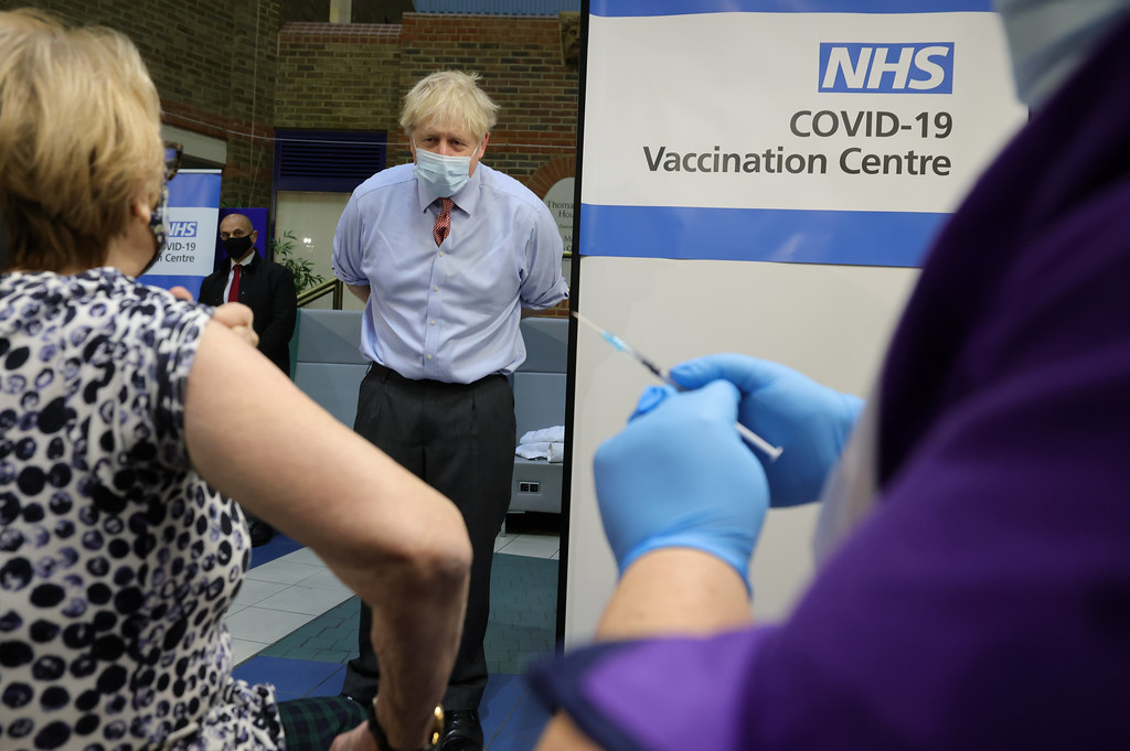 Boris Johnson visits Covid-19 Vaccine Centre. The Prime Minister watching Lyn Wheeler have her Covid-19 Vaccine injection at Guy's Hospital in central London, on the day the vaccine is rolled out across the country. Picture by Andrew Parsons / No 10 Downing Street 08/12/2020. London, United Kingdom.