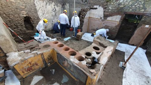 Scientists at work on the excavation of the "snack bar" recently uncovered in Pompeii.
