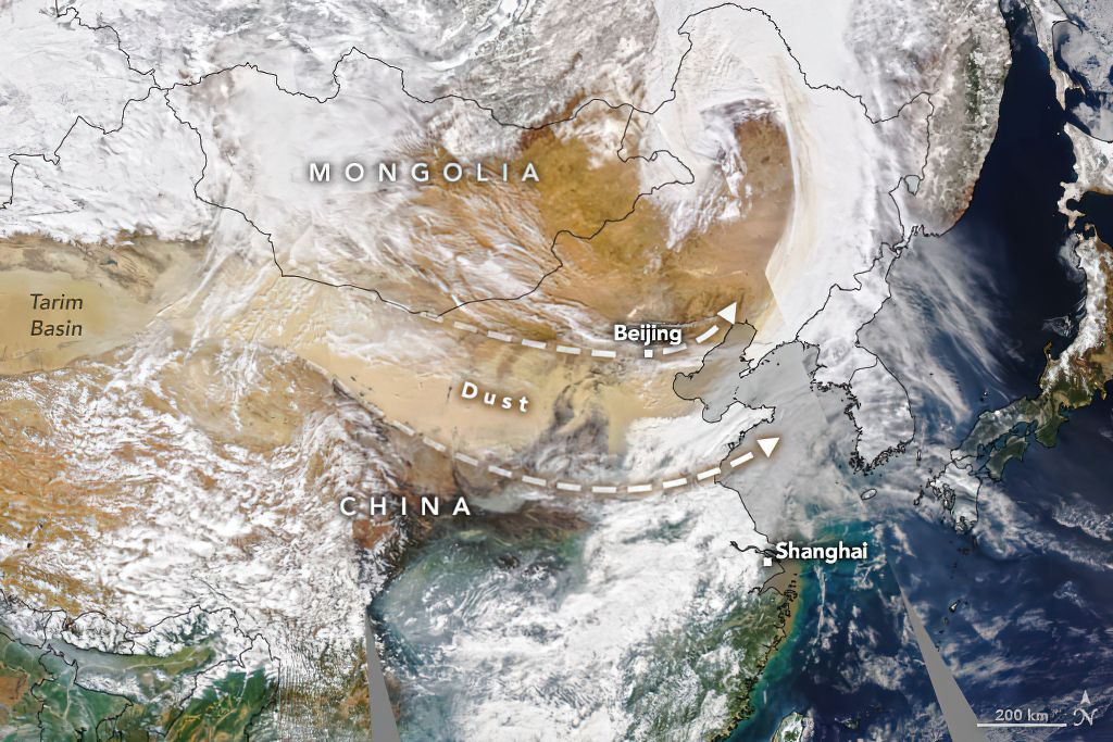 A labeled satellite image shows a dust plume originating from the Taklamakan Desert in northwest China and moving east toward Beijing.