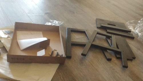 An unassembled IKEA flat pack stool