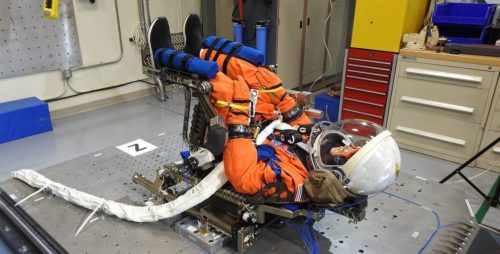 NASA's manikin dressed in an orange survival suit, positioned as it will be in the commander's seat in the Orion capsule.