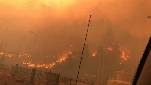 A hillside with utility lines on fire in one part of the Dixie Fire in California, July 22, 2021.