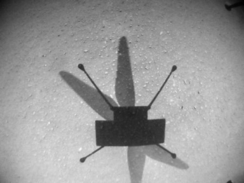 The shadow NASA's Mars helicopter Ingenuity is seen on the ground in a black and white picture taken on the helicopter's ninth flight.