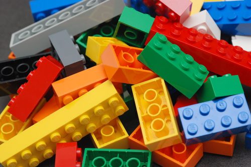 A pile of Lego blocks, of assorted colors and sizes.
