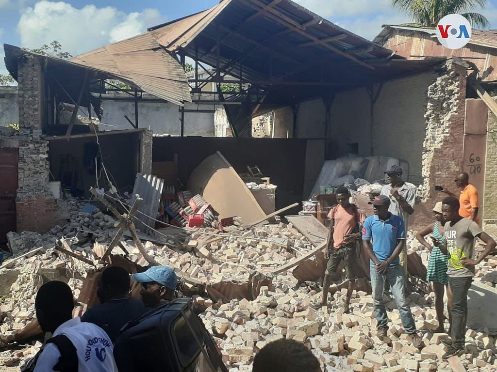 Haitians look at the rubble left by the August 14 earthquake.