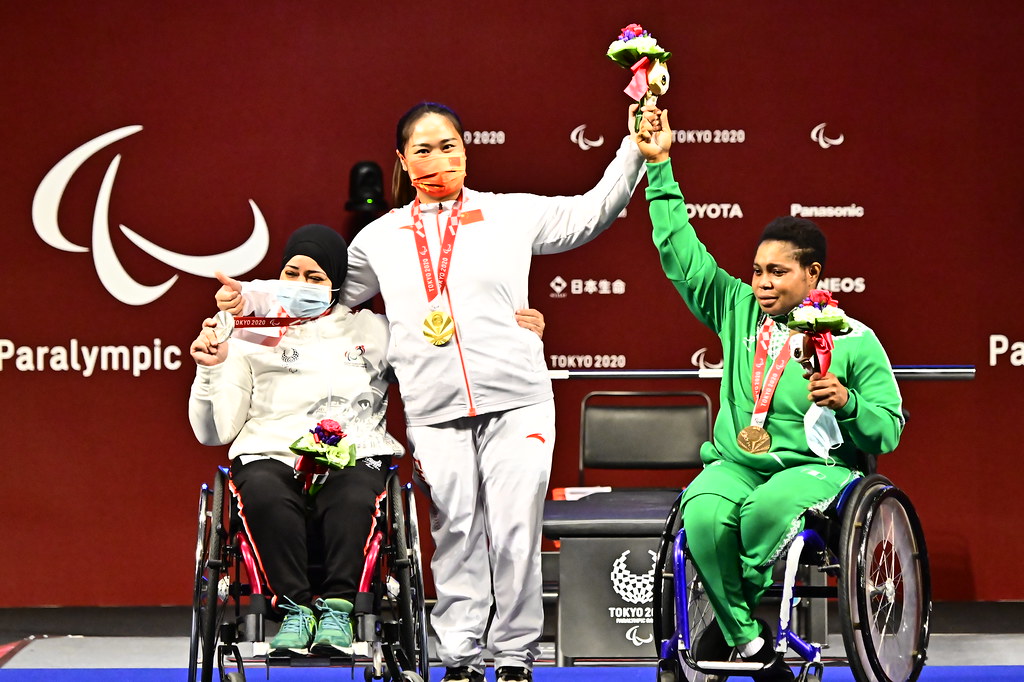 Yujiao Tan from China, gold medalist, Fatma Omar from Egypt, silver medalist, and Olaitan Ibrahim from Nigeria, bronze medalist in the women’s up to 67kg at the Tokyo International Forum during the Paralympic Games on 28 August.